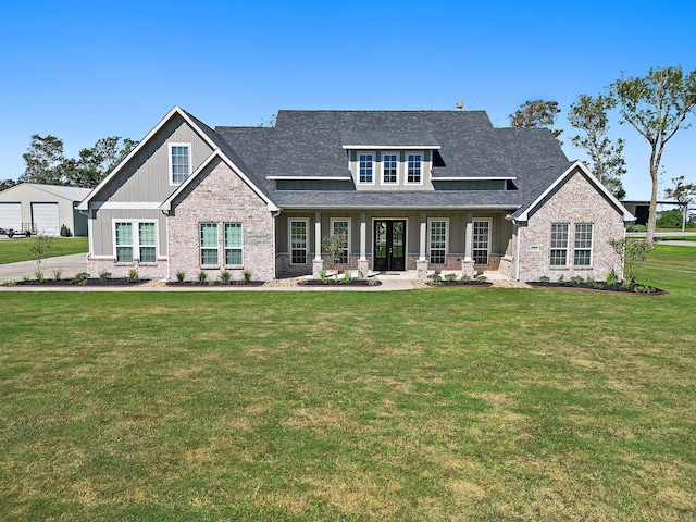 view of front facade featuring covered porch and a front lawn