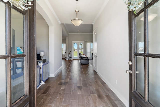 foyer entrance featuring french doors, crown molding, and dark wood-type flooring