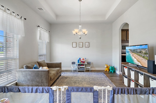 living room featuring dark hardwood / wood-style flooring and a chandelier