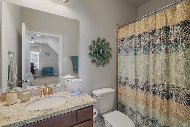 bathroom featuring ceiling fan, vanity, vaulted ceiling, and toilet