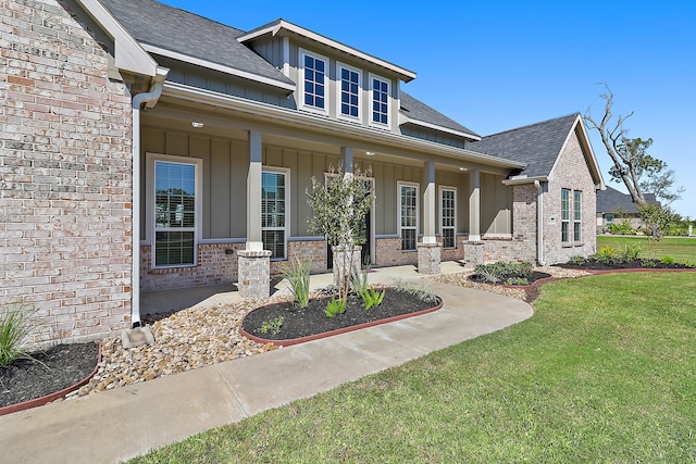 view of front of home with a front yard and a porch