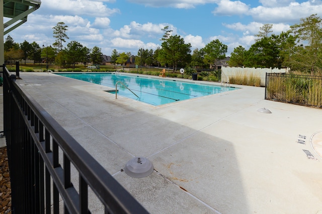 view of swimming pool featuring a patio area