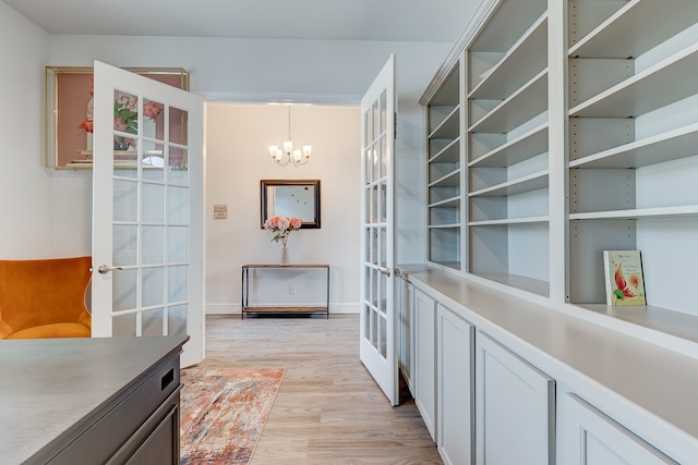 interior space with a chandelier and light hardwood / wood-style floors