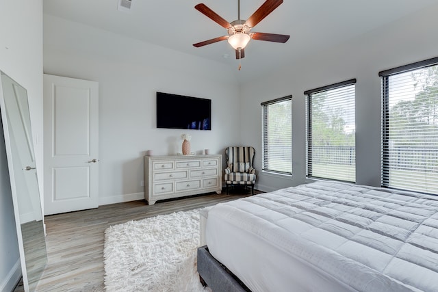 bedroom with light hardwood / wood-style flooring and ceiling fan