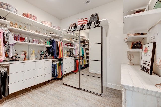 spacious closet with light hardwood / wood-style floors