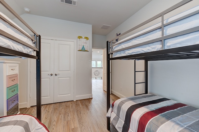 bedroom with light wood-type flooring and a closet