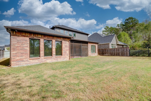 back of house featuring a yard