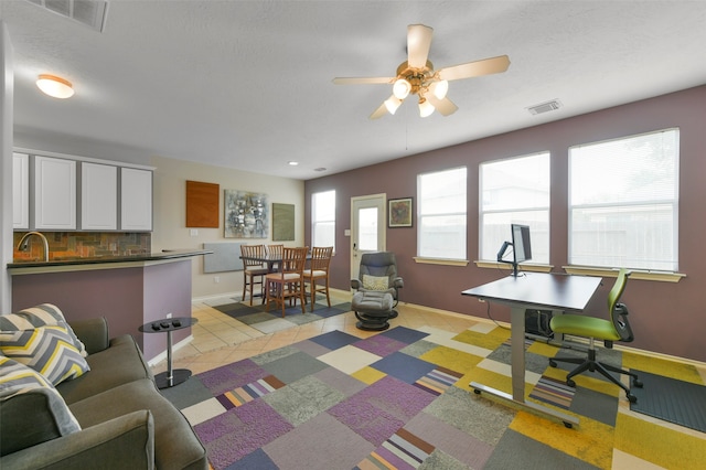 living room featuring ceiling fan and light tile patterned floors