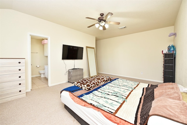 bedroom with ceiling fan, light colored carpet, connected bathroom, and vaulted ceiling