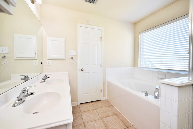 bathroom with vanity, tile patterned floors, and a tub