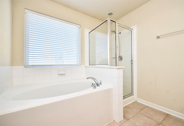 bathroom with tile patterned floors and separate shower and tub