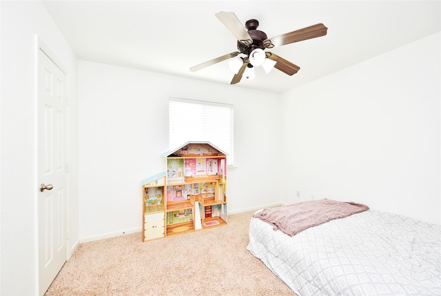 bedroom featuring ceiling fan and light carpet