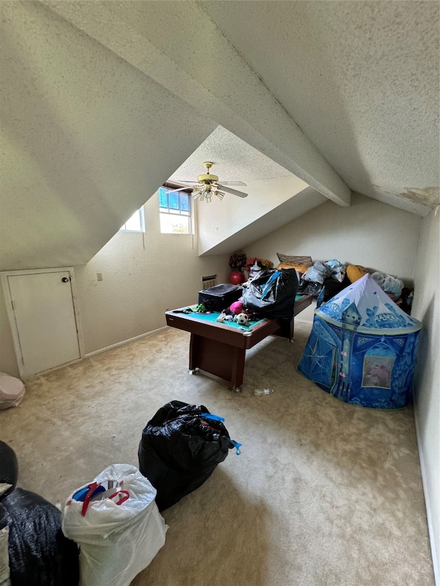 bonus room with carpet, a textured ceiling, ceiling fan, and lofted ceiling