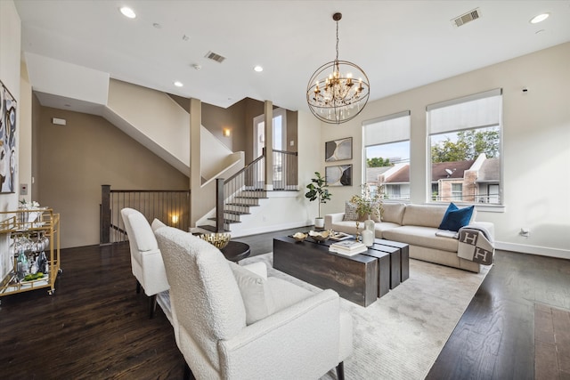 living room featuring a chandelier and dark wood-type flooring