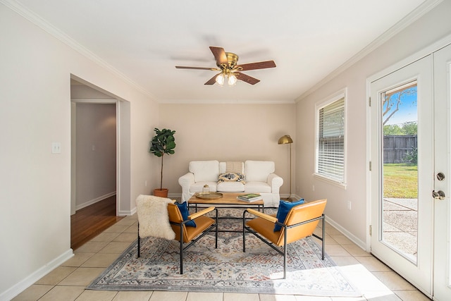 sitting room featuring ceiling fan, light tile patterned floors, and crown molding