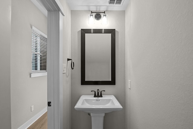 16022 Mason Run Dr, Houston, TX 77079 - bathroom featuring a sink, baseboards, visible vents, and wood finished floors