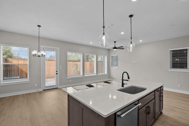 16022 Mason Run Dr, Houston, TX 77079 - kitchen with a sink, stainless steel dishwasher, ceiling fan with notable chandelier, and light wood-style floors