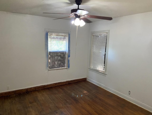 empty room featuring dark hardwood / wood-style floors and ceiling fan