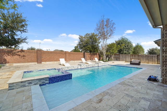 view of swimming pool featuring an in ground hot tub and a patio