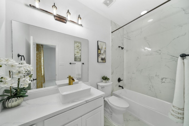 full bathroom featuring vanity, toilet, and tiled shower / bath