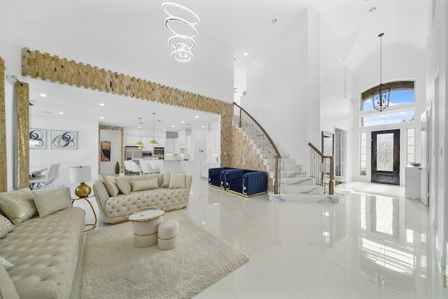 living room featuring a notable chandelier, light tile patterned floors, and a high ceiling