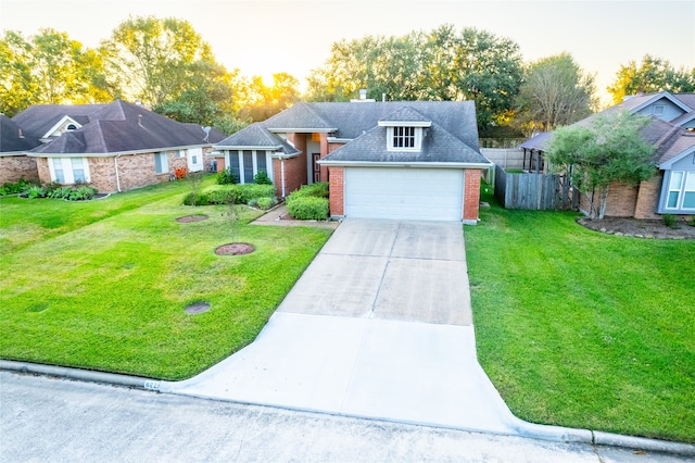 view of front of home featuring a yard and a garage