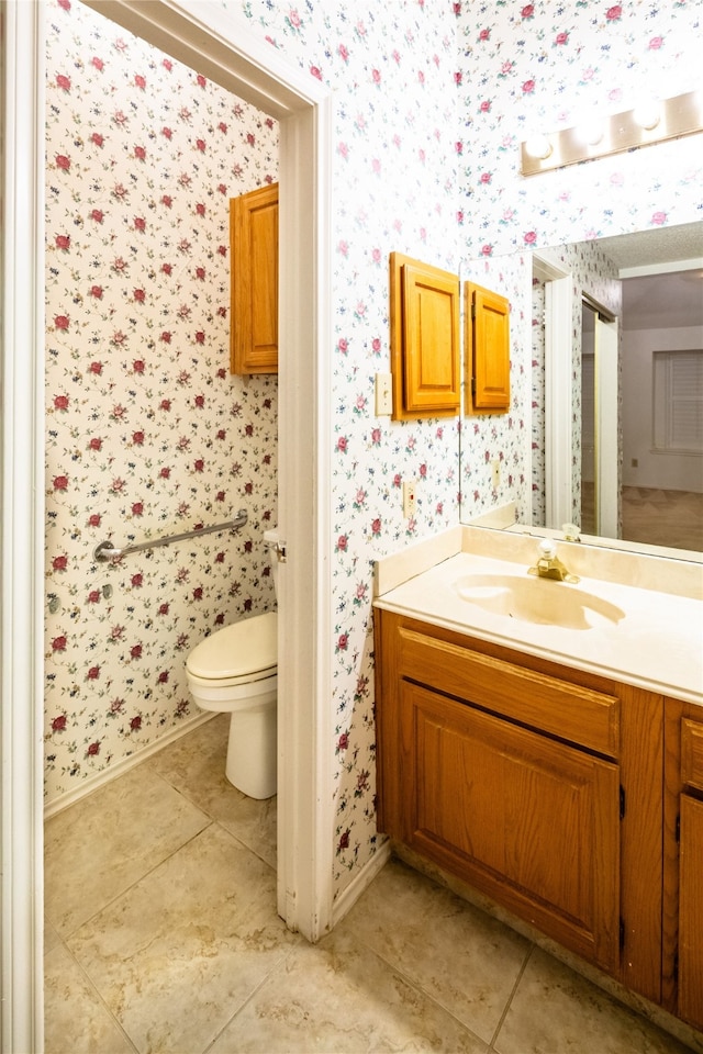 bathroom featuring tile patterned flooring, vanity, and toilet