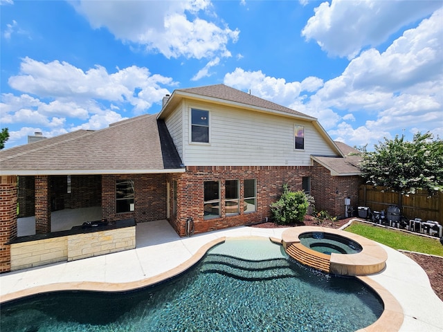 view of pool featuring an in ground hot tub and a patio