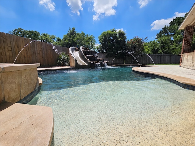 view of pool featuring pool water feature, a patio area, and a water slide