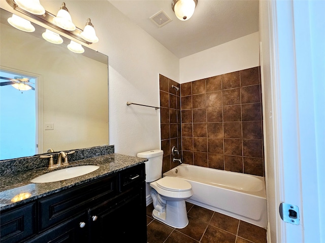 full bathroom with vanity, tile patterned floors, tiled shower / bath, ceiling fan, and toilet