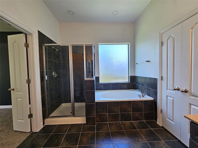 bathroom with tile patterned floors, plus walk in shower, and vanity