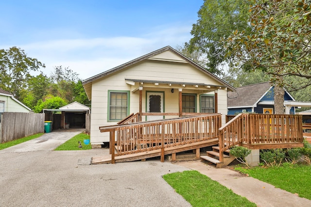 view of front of property with a porch, an outdoor structure, and a garage