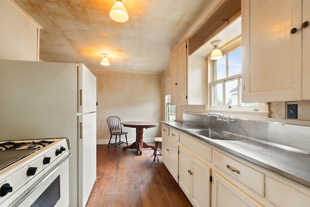 kitchen featuring stainless steel counters, dark hardwood / wood-style flooring, sink, and white stove