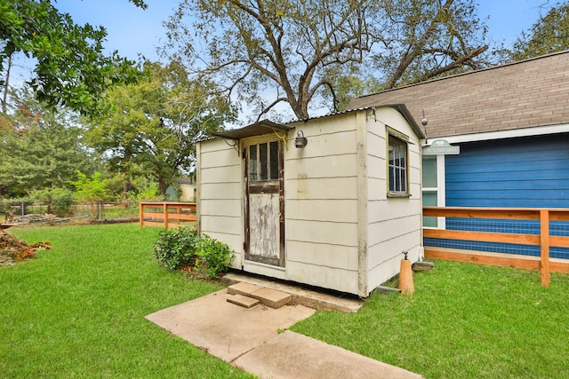 view of outbuilding with a yard