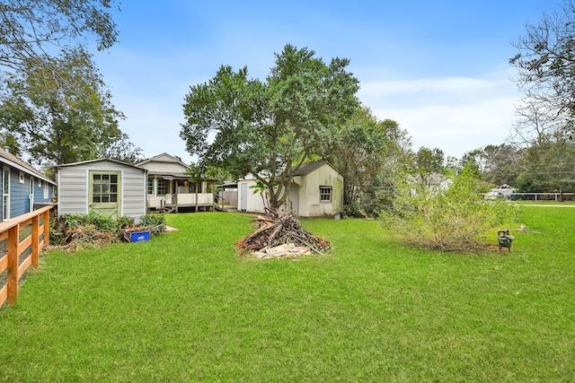 view of yard with an outdoor structure and a wooden deck