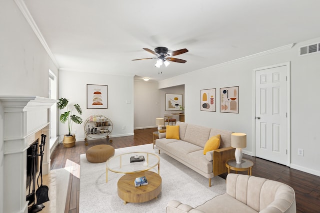 living room with ceiling fan, wood-type flooring, and ornamental molding