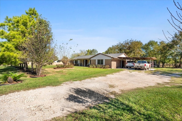 single story home featuring a front lawn and a carport