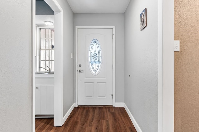 doorway with dark wood-type flooring