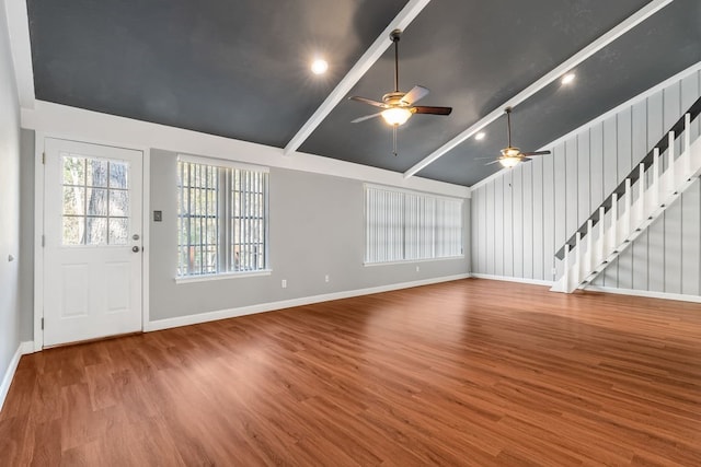 unfurnished living room with beamed ceiling, ceiling fan, wood-type flooring, and high vaulted ceiling