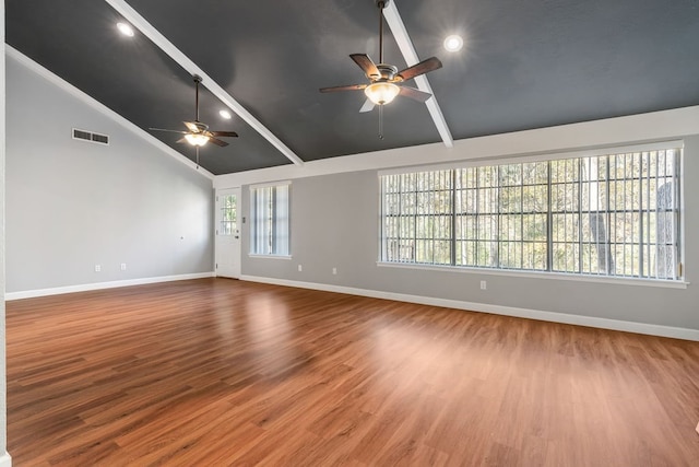 empty room with beamed ceiling, ceiling fan, wood-type flooring, and high vaulted ceiling