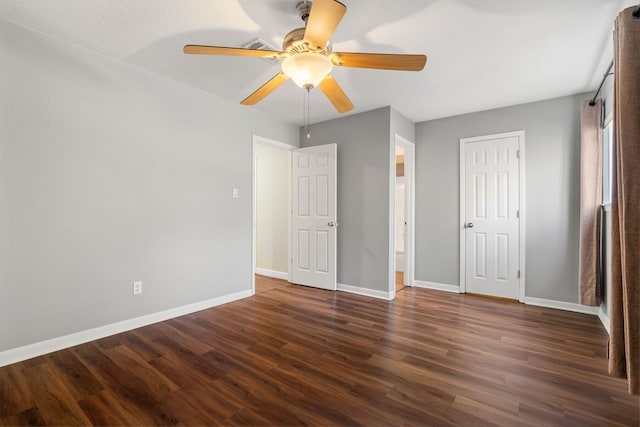 unfurnished bedroom with ceiling fan and dark hardwood / wood-style flooring