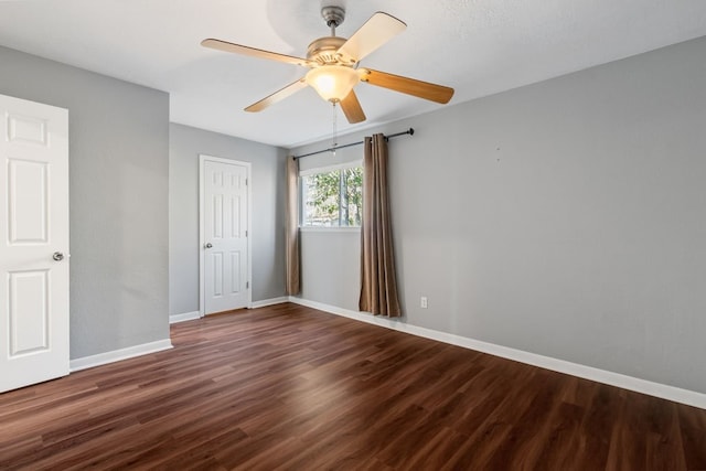 unfurnished room featuring ceiling fan and dark hardwood / wood-style flooring