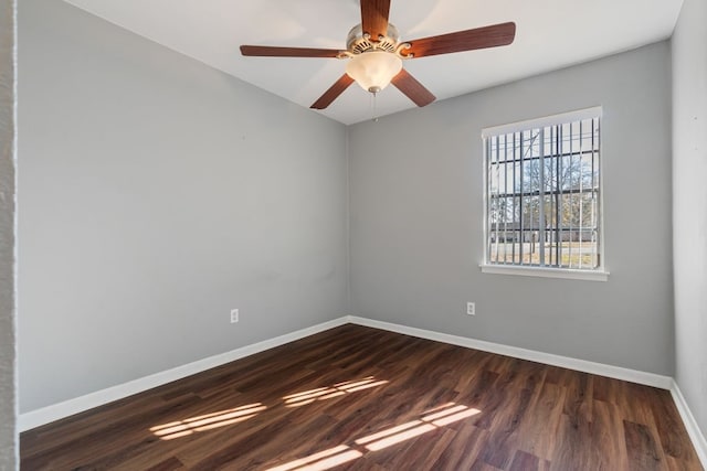 unfurnished room featuring ceiling fan and dark wood-type flooring