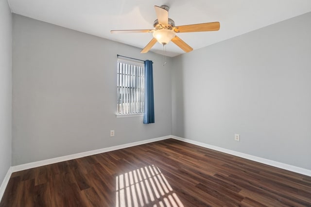 unfurnished room with dark hardwood / wood-style flooring and ceiling fan