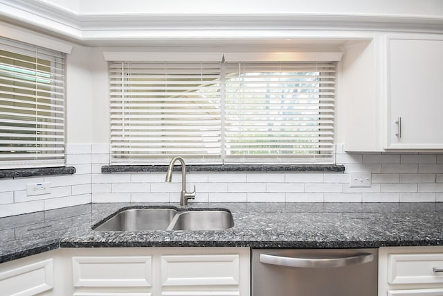 kitchen with stainless steel dishwasher, sink, and white cabinets