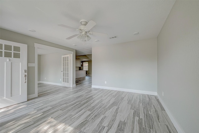 empty room featuring light wood-type flooring and ceiling fan