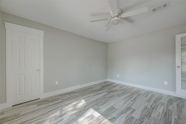 unfurnished room with light hardwood / wood-style flooring and ceiling fan