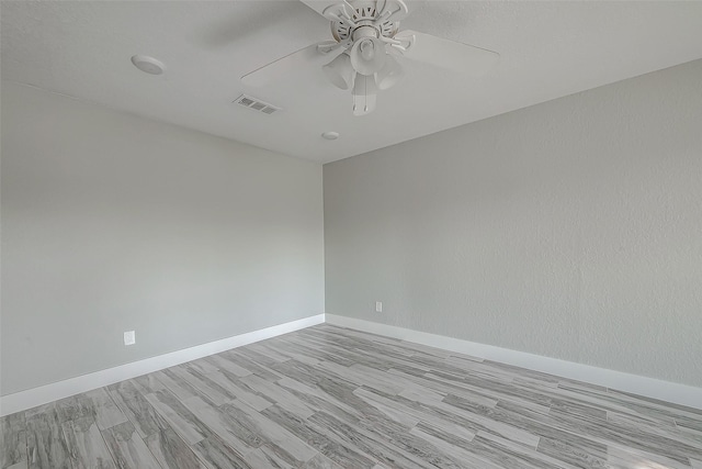 unfurnished room with ceiling fan and light wood-type flooring