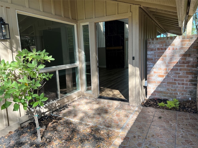 view of exterior entry featuring a patio area