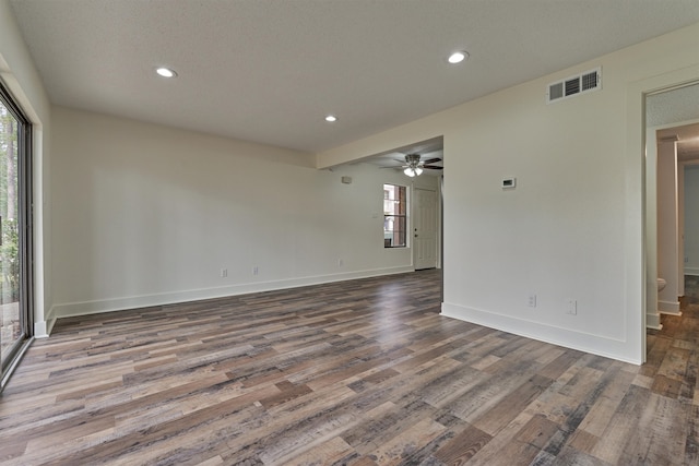 spare room with hardwood / wood-style flooring, ceiling fan, and a textured ceiling